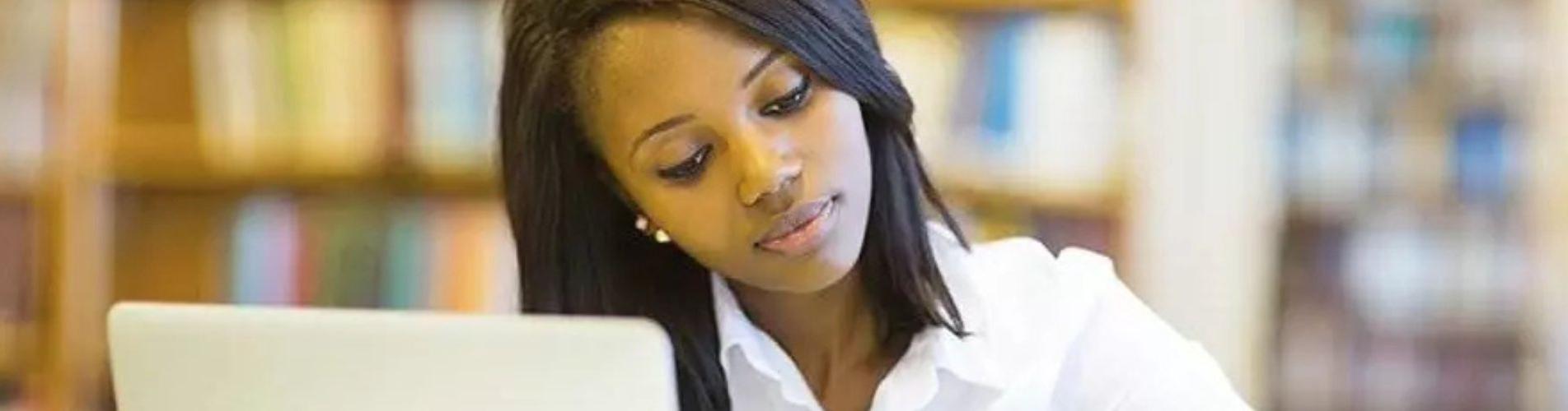 Woman working on her laptop in a library